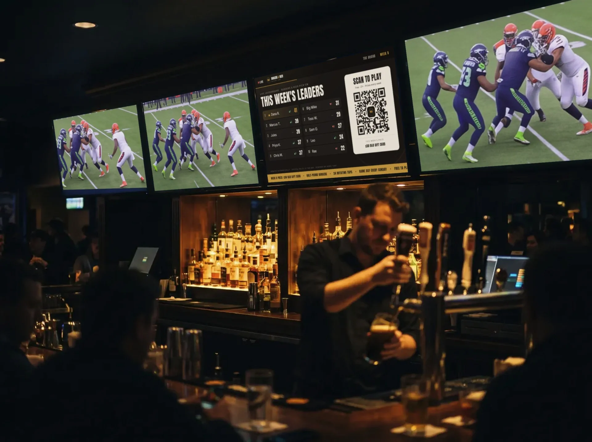A live Standing Room venue board on a row of TVs above the bar